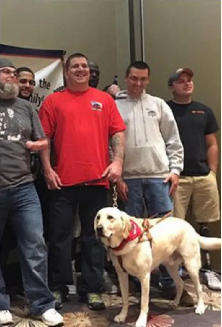 A group of men standing with a service dog