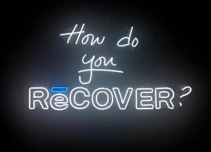 Neon sign reading How do you RēCOVER?