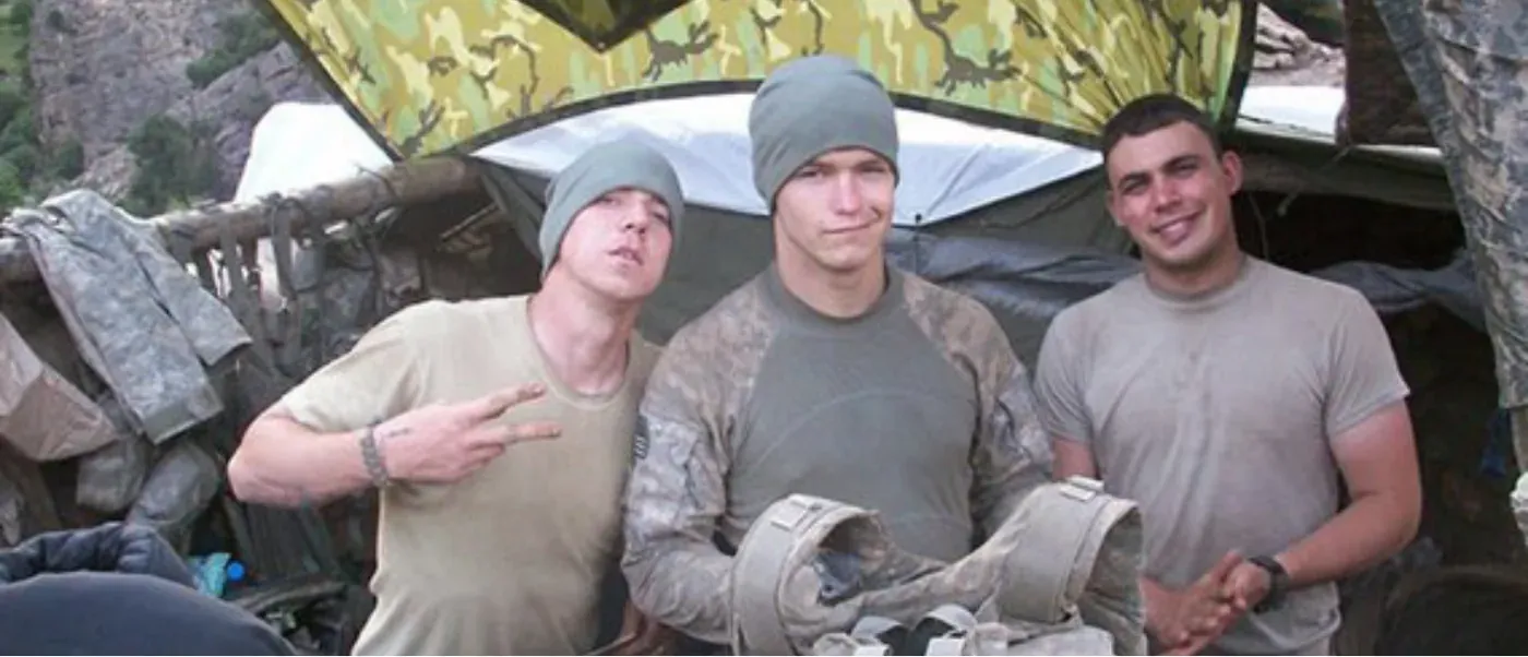 Three soldiers in uniform posing together