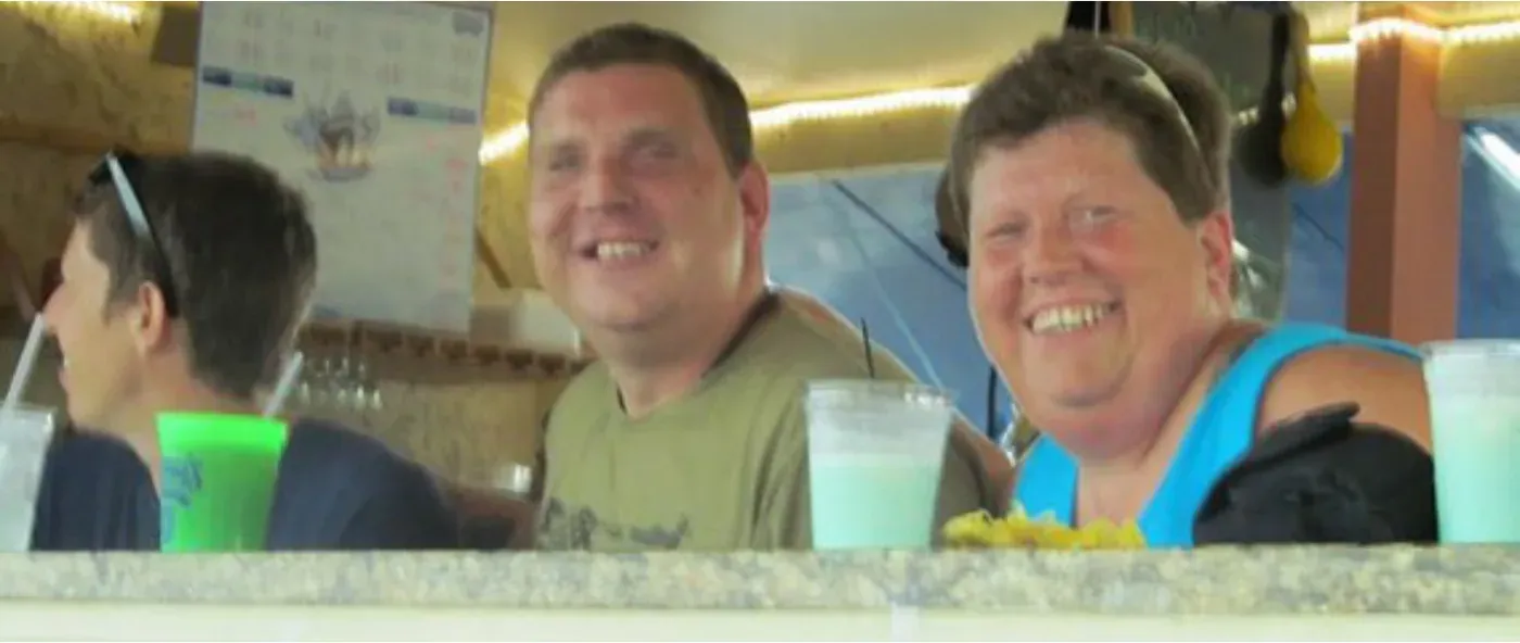 Three people smiling at a restaurant table
