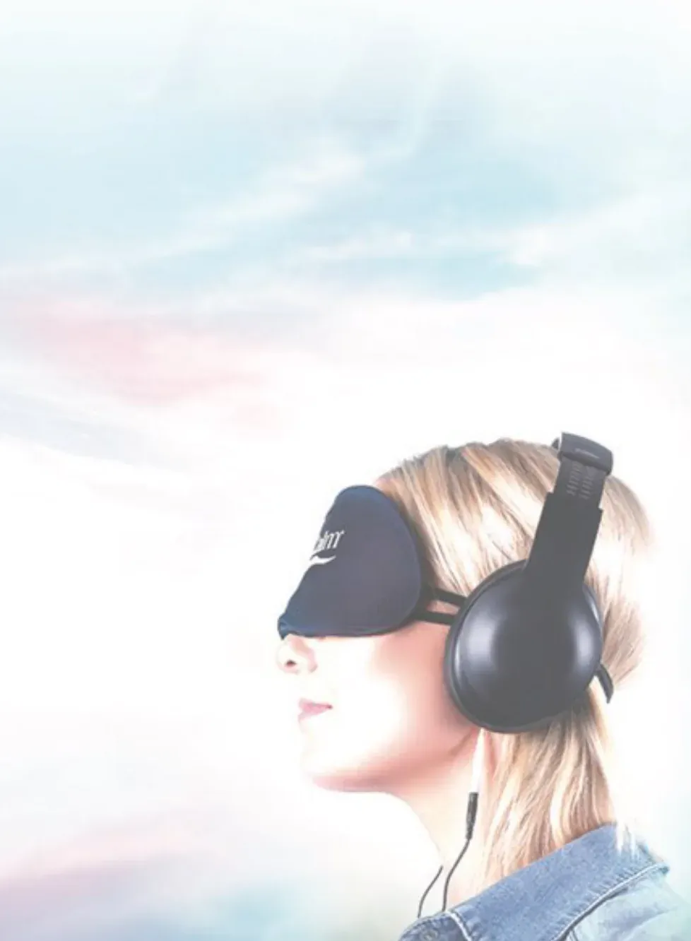 A woman wearing a NuCalm eye mask and headphones
