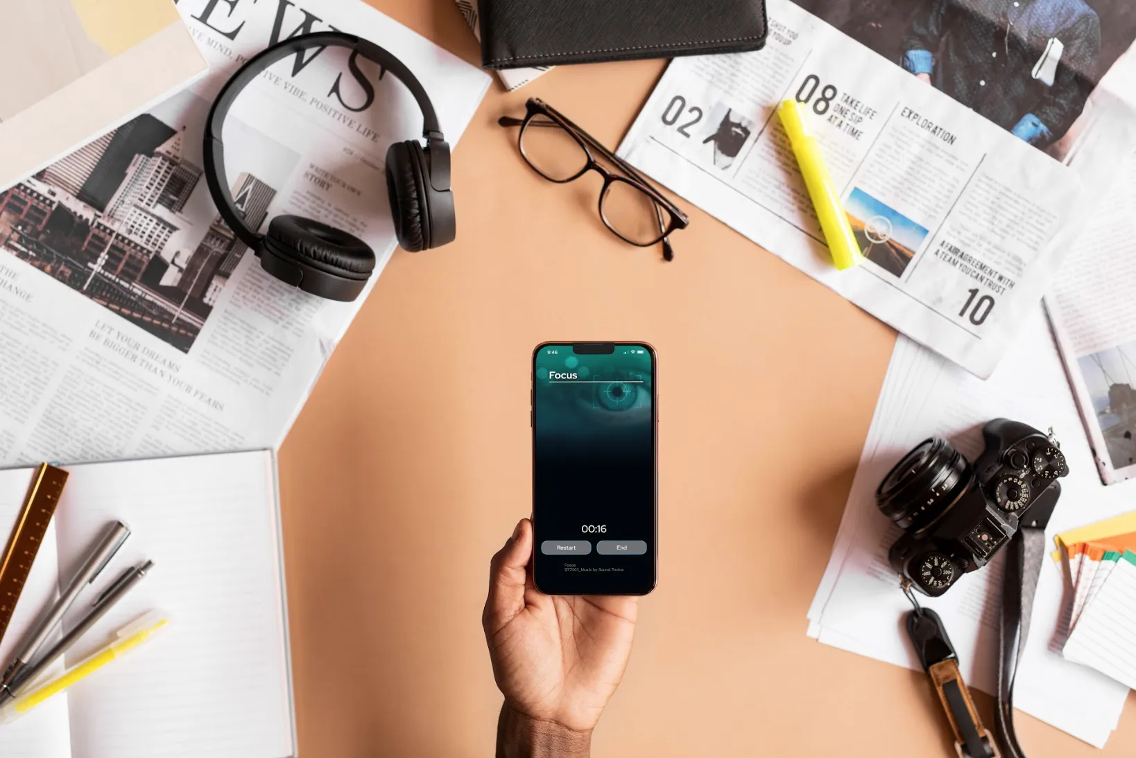 A person holding a smartphone with the NuCalm app Focus screen open.