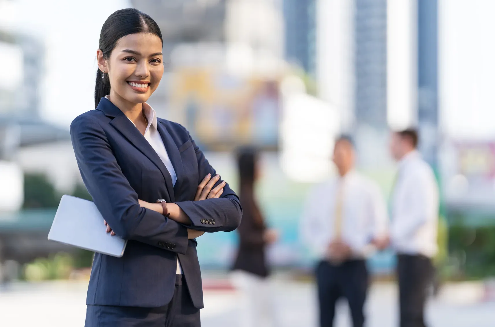 Businesswoman standing confidently, dressed in professional attire.