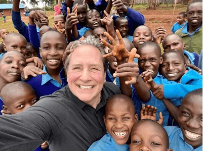 Jim Poole with students during NuCalm's mission to Kenya