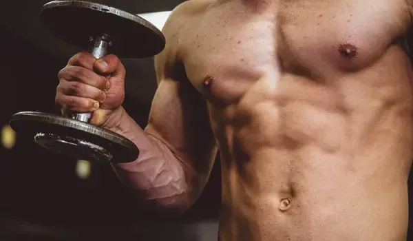 Athlete lifting weights to build muscle memory